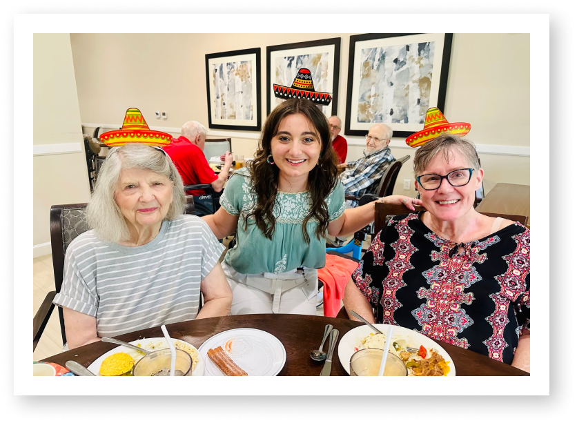 Residents and Staff Enjoying a Festive Cultural Celebration at a Memory Care Facility