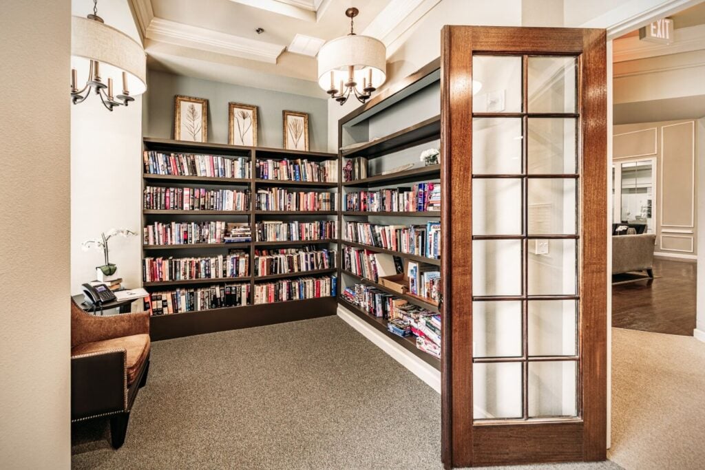 Well-Stocked Resident Library With Floor-to-Ceiling Bookshelves in Independent Living