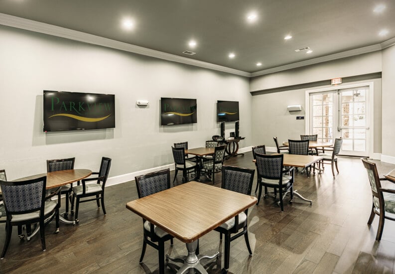 Modern Casual Dining Room With Flat Screen TVs and Wood Tables at an Assisted Living Facility Modern Casual Dining Room With Flat Screen TVs and Wood Tables at an Assisted Living Facility