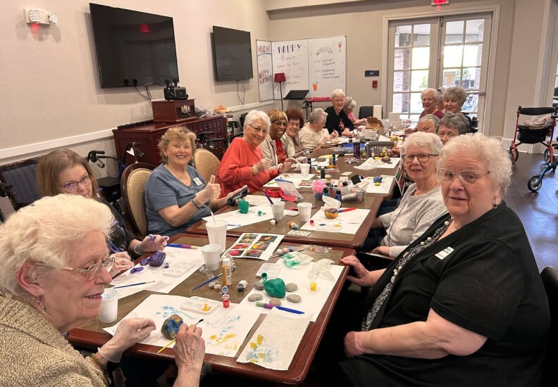 Elderly Women Enjoying a Group Rock Painting Activity at an Assisted Living Community