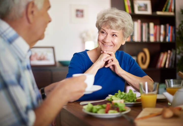 Elderly Couple Sharing a Healthy Meal and Conversation During Respite Care Elderly Couple Sharing a Healthy Meal and Conversation During Respite Care
