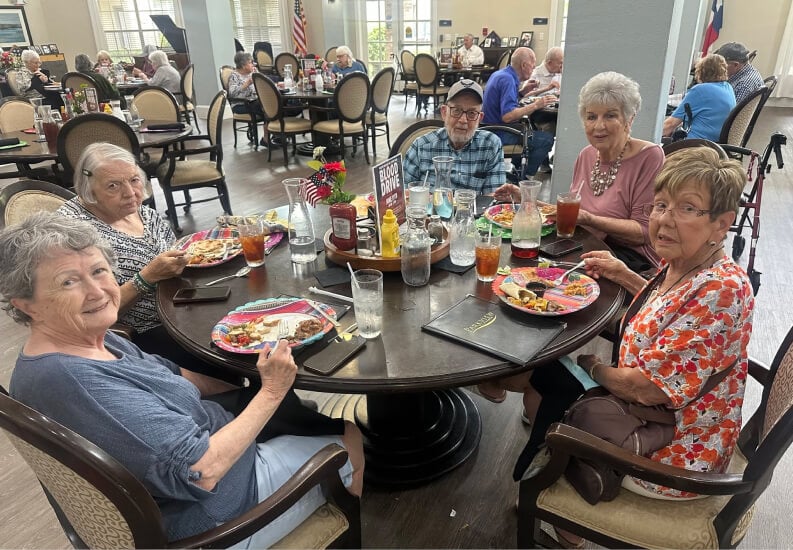 Elderly Residents Enjoying a Meal Together in the Community Dining Room at Memory Care Elderly Residents Enjoying a Meal Together in the Community Dining Room at Memory Care