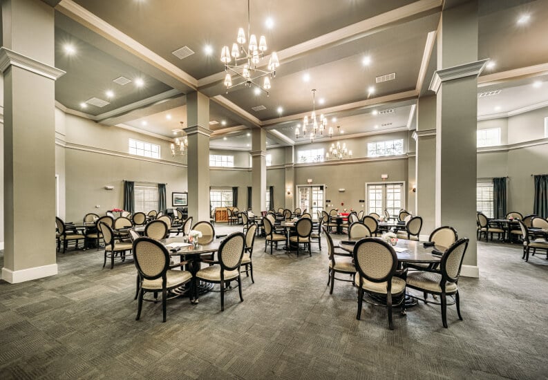 Grand Chandelier Dining Hall With Elegant Round Tables at an Independent Living Community Grand Chandelier Dining Hall With Elegant Round Tables at an Independent Living Community