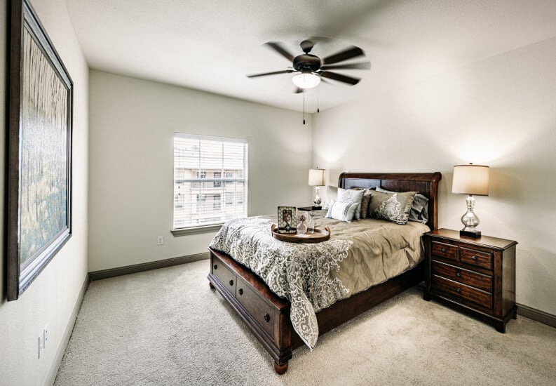 Spacious Resident Bedroom With Dark Wood Furniture and Natural Light at an Assisted Living Community Spacious Resident Bedroom With Dark Wood Furniture and Natural Light at an Assisted Living Community