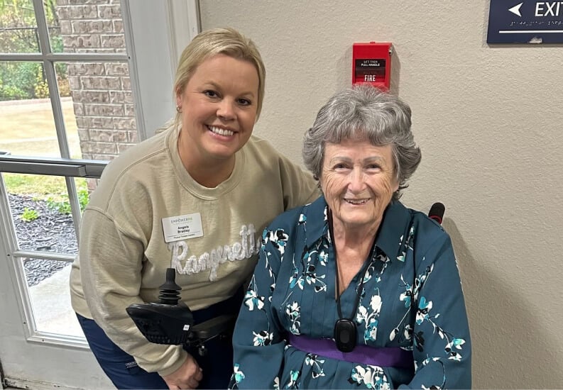 Caring Staff Member Smiling With an Elderly Resident Receiving Respite Care Caring Staff Member Smiling With an Elderly Resident Receiving Respite Care