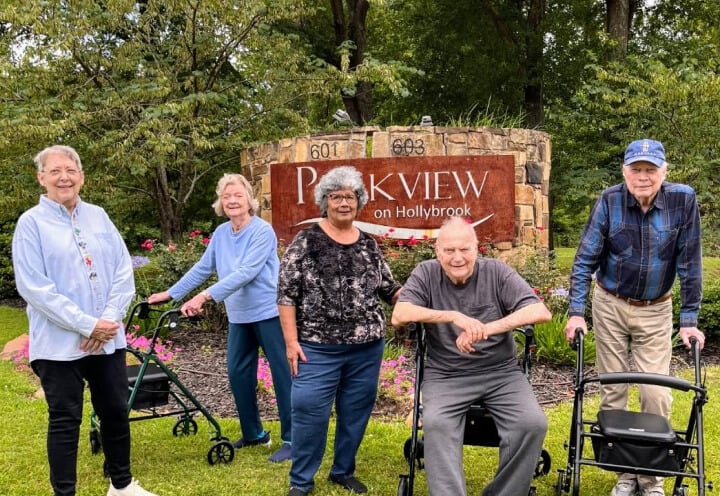 Elderly Residents Smiling Outside at an Assisted Living Community Elderly Residents Smiling Outside at an Assisted Living Community