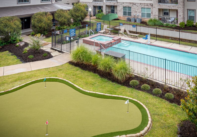 Outdoor Putting Green and Swimming Pool With Landscaped Grounds at an Independent Living Community Outdoor Putting Green and Swimming Pool With Landscaped Grounds at an Independent Living Community